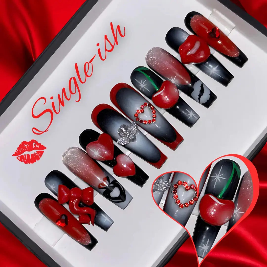 Red and black press-on nails with 3d hearts, bows and cherry’s